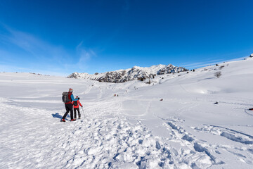 Winter sports on Lessinia Plateau and the mountain range of Monte Carega (Small Dolomites). Malga San Giorgio ski resort, Bosco Chiesanuova municipality, Veneto and Trentino Alto Adige, Italy, Europe.