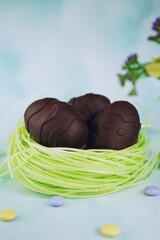 Homemade Chocolate surprise Easter Eggs on beautiful spring background, selective focus