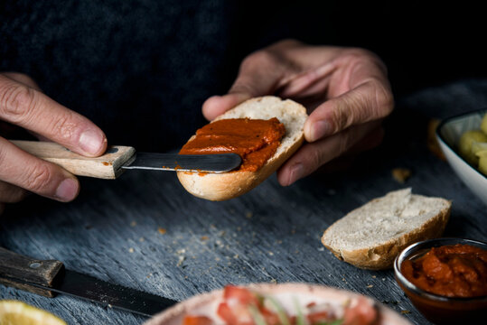 man spreading vegan sobrasada on a piece of bread