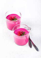 Vegan Panna Cotta beet cranberry in a glass on a white background