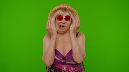 Funny amusing senior pensioner woman tourist in swimsuit, fooling around making stupid brainless...