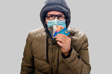 Young man in protective medical mask shopping in online store