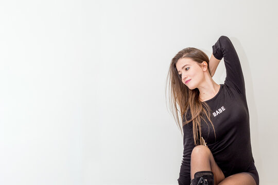 Beautiful young smiling woman over white wall