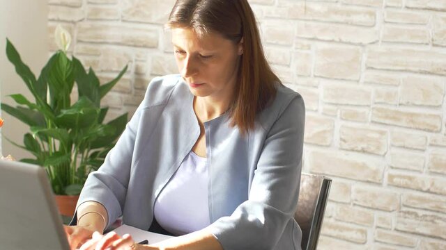 Business woman typing on laptop computer working at home using  internet. Female professional working notebook at home