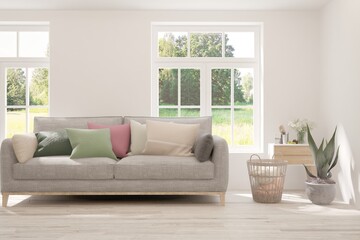 Minimalist living room in white color with sofa and summer landscape in window. Scandinavian interior design. 3D illustration