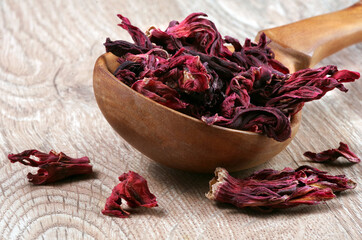 Hibiscus tea. Hibiscus tea in a wooden spoon. Vitamin tea for cold and flu.	