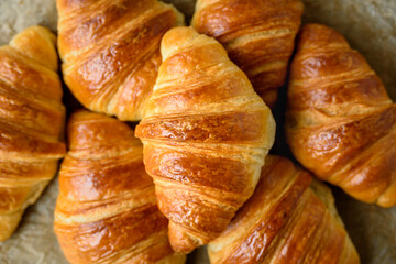 Fresh baked puff pastry croissants on baking paper
