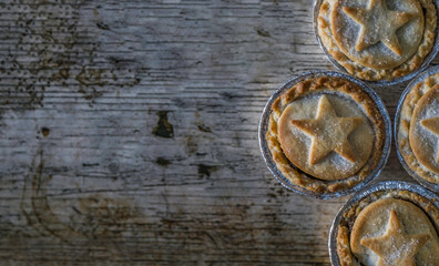 Fototapeta na wymiar Flat Lay Image of Some British Mince Pies on a Wooden Textured Background With Copy Space or Space for Text
