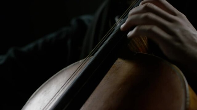 The cellist performs on stage.