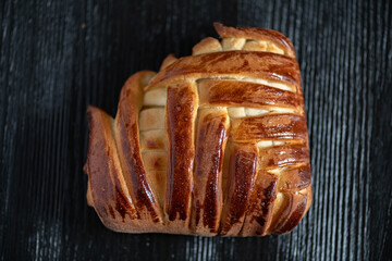 Appetizing fresh homemade buns on a wooden background, close-up.