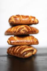 Appetizing fresh homemade buns on a wooden background, close-up.