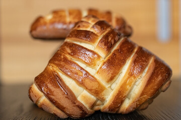 Appetizing fresh homemade buns on a wooden background, close-up.
