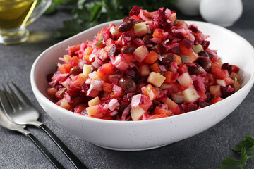 Traditional salad Vinaigrette of beets, potatoes, carrots, beans, pickles, onions and vegetable oil on gray background. Vegetarian food