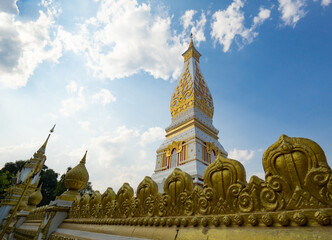 Naklejka premium The Pagoda of Wat Phra That Panom temple in Nakhon Phanom, Thailand in cloudy blue sky day with sunlight