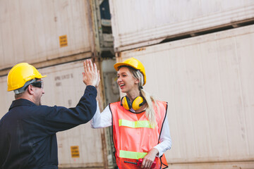 worker giving high five to his friend colleague. Workers hands touching and clapping for sucessfully. Container Shipping Logistics Engineering concept