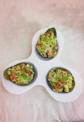 Avocado salad serving on plate,blurry light around