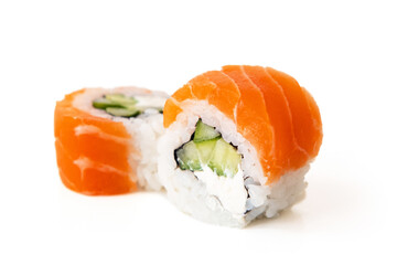 Fototapeta Salmon sushi maki rolls with avocado and cucumber filling, isolated on white background obraz