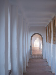 corridor with arches and columns