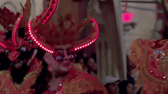 Dancers wearing Devil Costumes with LED Strip Lights on Head in Oruro Carnival, Bolivia, South America. 4K Resolution.