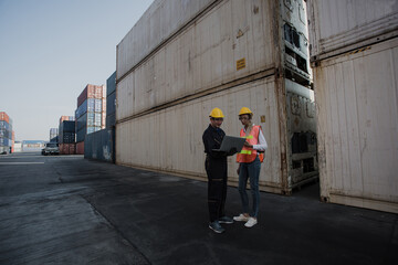 Fototapeta na wymiar working engineer in the construction container yard. worker and supervisor checking containers data. Container Shipping Logistics Engineering concept