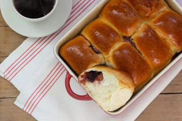Austrian buns with cherry filling in a baking dish. Rustic style.