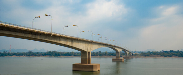 Third Thai&ndash;Lao Friendship Bridge, is a bridge over Mekong river that connects Nakhon Phanom Province in Thailand with Thakhek, Khammouane in Laos in cloudy blue sky day