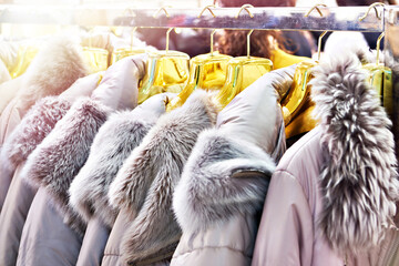 Winter jackets with grey fur collars in clothing store