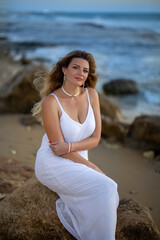 Fototapeta na wymiar Beautiful woman sitting near the sea