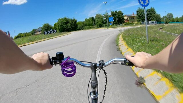 Riding on a bike on a rural roundabout in Italy pov