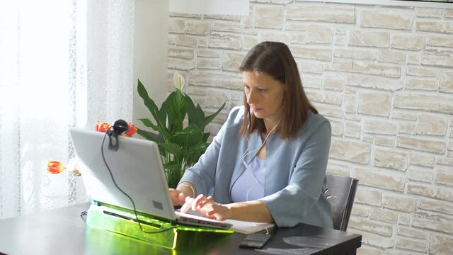 Business woman typing on laptop computer working at home using  internet. Female professional working notebook at home 