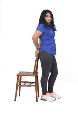 woman playing with a chair in white background, front view,