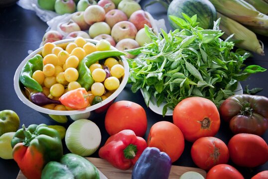Table full of fresh vegetables and fruits