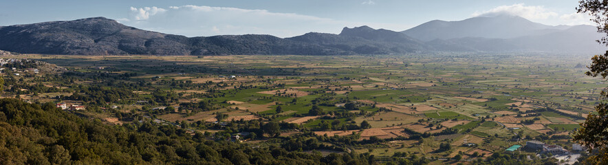 Panorama of fields with beautiful clouds on Lassithi plateau Crete Greece