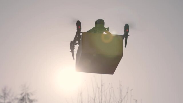 big delivery drone with package attached against the sunlight