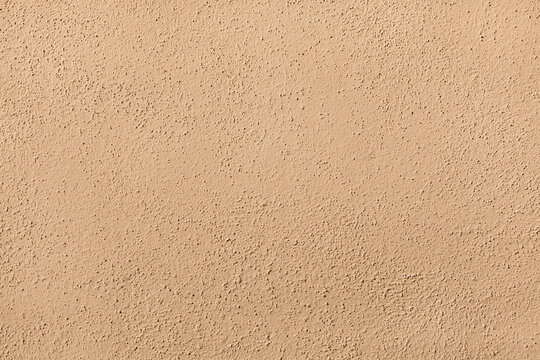 Beige painted stucco wall. Background texture