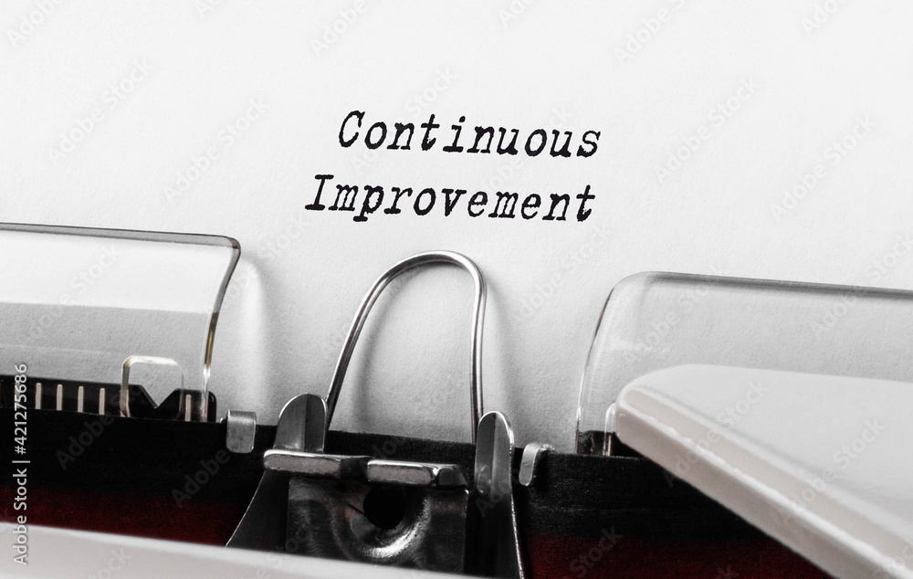 Poster text continuous improvement typed on retro typewriter