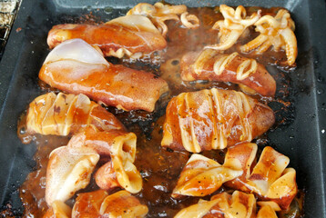 The squid is sliced and marinated with spices. Grilled on a frying pan.