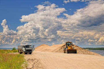 Front-end loader and dump truck in the river port