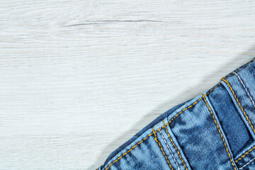 Denim trousers on a background of bleached wood.