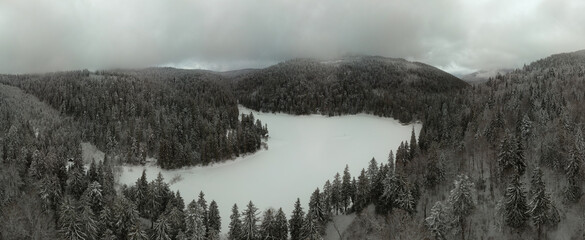 Aerial view. Frozen alpine lake. Covered in snow. High snowfall this winter. widescreen panorama of large resolution. Lake Synevyr, Ukraine