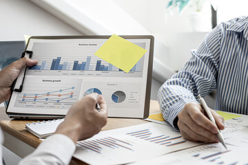 Finance workers are working together to prepare company financial documents for the meeting with management, together they are checking the accuracy of the information. Financial concept.
