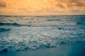 Seascape in the early morning. Sunrise over the stormy sea. Nature landscape