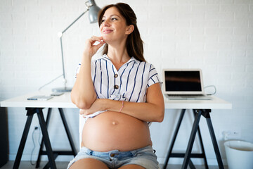 Pregnant woman working from home. Career and pregnancy concept