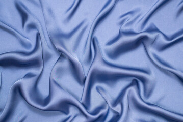 Blue silk or satin luxury fabric texture. Top view.