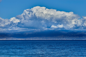 threatening clouds gather on the coast of Calabria and on the calm blue sea