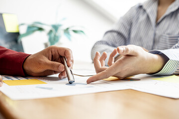 The sales department is having a monthly summary meeting to bring it to the department manager, they are verifying the correctness of the documents that are prepared before bringing in to the manager