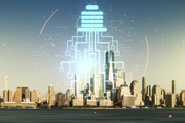 Double exposure of virtual creative light bulb hologram with chip on New York city skyscrapers...