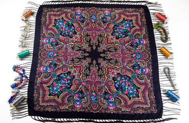 top view flat lay on black cotton scarf with fringe and bright floral ornament