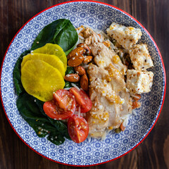 Fresh salad with chicken breast, arugula and tomato