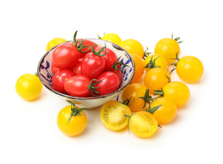 yellow and red cherry tomatoes on white background.